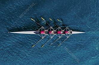 Women`s rowing team on blue water