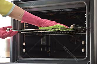 Cleaning the oven. Clean oven in kitchen.