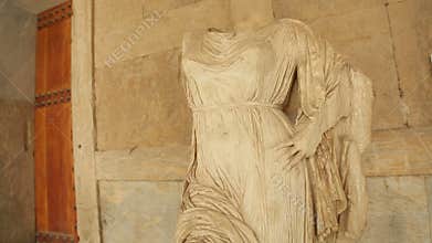 Headless female marble stone statue of goddess at museum, cultural heritage