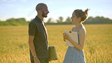 Agribusiness people. Farmer with computer speaking with agriculture scientist