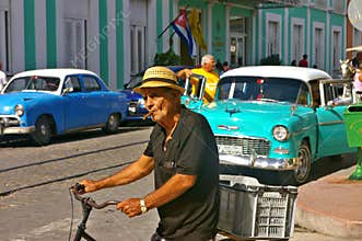 Old man smoking a cigar in the street
