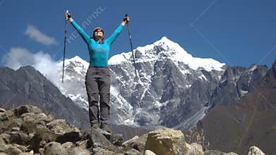 The girl climbs to the top of the cliff