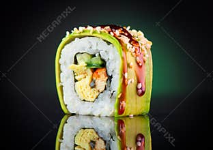 Sushi roll over black background. Sushi roll with eel, tofu, vegetables and avocado closeup
