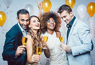 Group of party people celebrating with drinks
