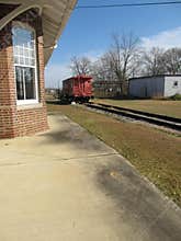 Train station with caboose in distance