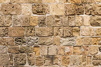 Ancient natural stone wall as a texture or background.