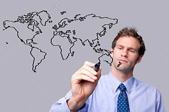 Businessman drawing the world map on a glass scree