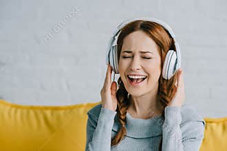 Beautiful woman listening to music and singing