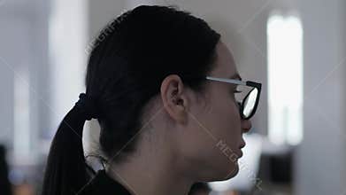 Frustrated business woman has no fun while working and thinks about something in the office closeup