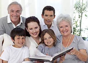 Smiling family looking at a photograph album