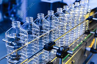 Bottle. Industrial production of plastic pet bottles. Factory line for manufacturing polyethylene bottles. Transparent food packag