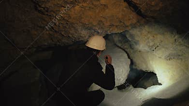 The speleologist finds and goes in passage in the cave. 4K