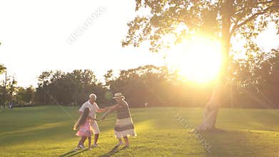 Leisure of grandparents with grandchild in park.