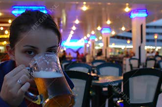 Young girl drinking a beer