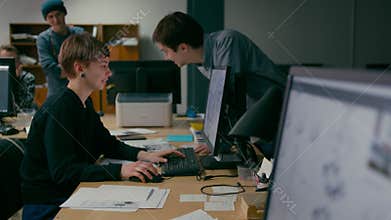 Team of Emploees is Discussing the Project Working in the Office with Computers