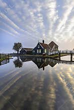 Dutch house mirrored on the calm canal