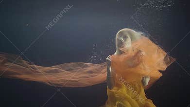 Woman model swimming like mermaid underwater pool on dark background