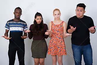 Studio shot of diverse group of multi ethnic friends looking con