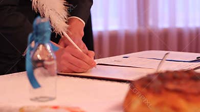 Bridegroom neatly signing marriage certificate, couple in love creating family