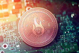 Shiny copper BILLIONAIRE cryptocurrency coin on blurry motherboard background