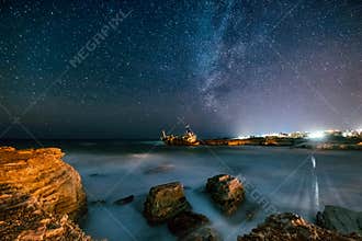 Abandoned ship Edro III near Cyprus beach at night.