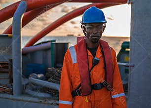 Seaman AB or Bosun on deck of vessel or ship , wearing PPE