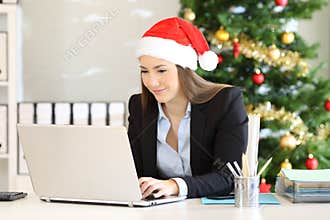 Office employee working in christmas with a laptop