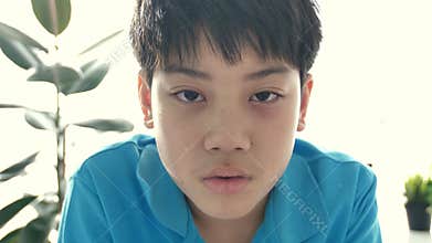 Portrait of asian crying preteen looking at camera with sad face,