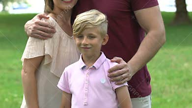 Orphan found family, loving parents hugging adopted child, happy childhood