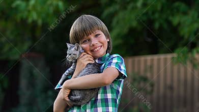 Smiling little boy posing with small cute kitty, adoption programs, family