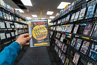 AUGUST 12 2018 - FAIRBANKS ALASKA: Hand holding an old DVD rental case from Blockbuster Video