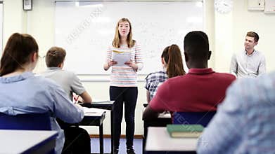 Female Student Giving Presentation To High School Class In Science Lesson