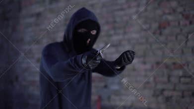 Unidentified robber with knife extorting money, threatening by weapon, burglary