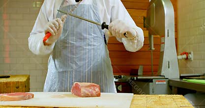 Butcher sharping knife and chopping meat 4k