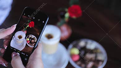 Food photography. Woman photographing coffee on phone closeup