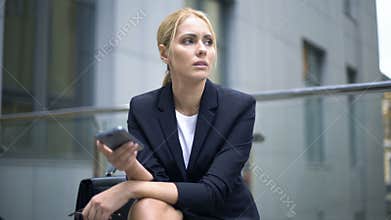 Businesswoman upset with message in smartphone, troubles at work, depression