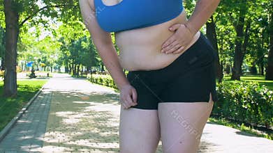 Obese girl feeling sharp pain in left back during jogging, exhausting workout