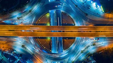 Timelapse of night city traffic on 4-way stop street intersection circle roundabout in bangkok, thailand. 4K UHD horizontal aerial