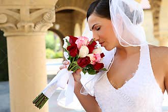 Bride smelling wedding bouquet