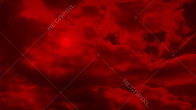 Apocalyptic red sky with sun behind the clouds