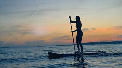 Athletic lady in the sunset. Summer holiday travel concept.