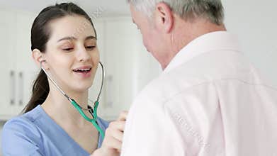 Man Having Health Check With Female Doctor