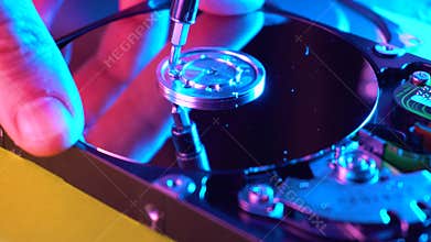 Man engineer repairing HDD drive using screwdrive