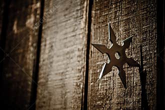Shuriken star embedded in wood