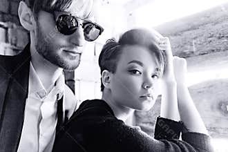 Boy and girl are posing in the walls of an old house. Black and white