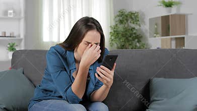 Woman suffering eyestrain using smart phone
