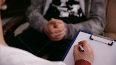 Young worried teenager at counseling - closeup on hands
