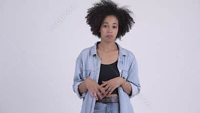 Young confused African woman shrugging shoulders