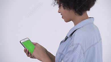 Rear view of young happy African woman using phone