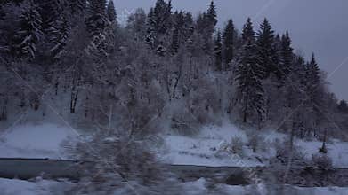 Traveling by train snowy woods with river